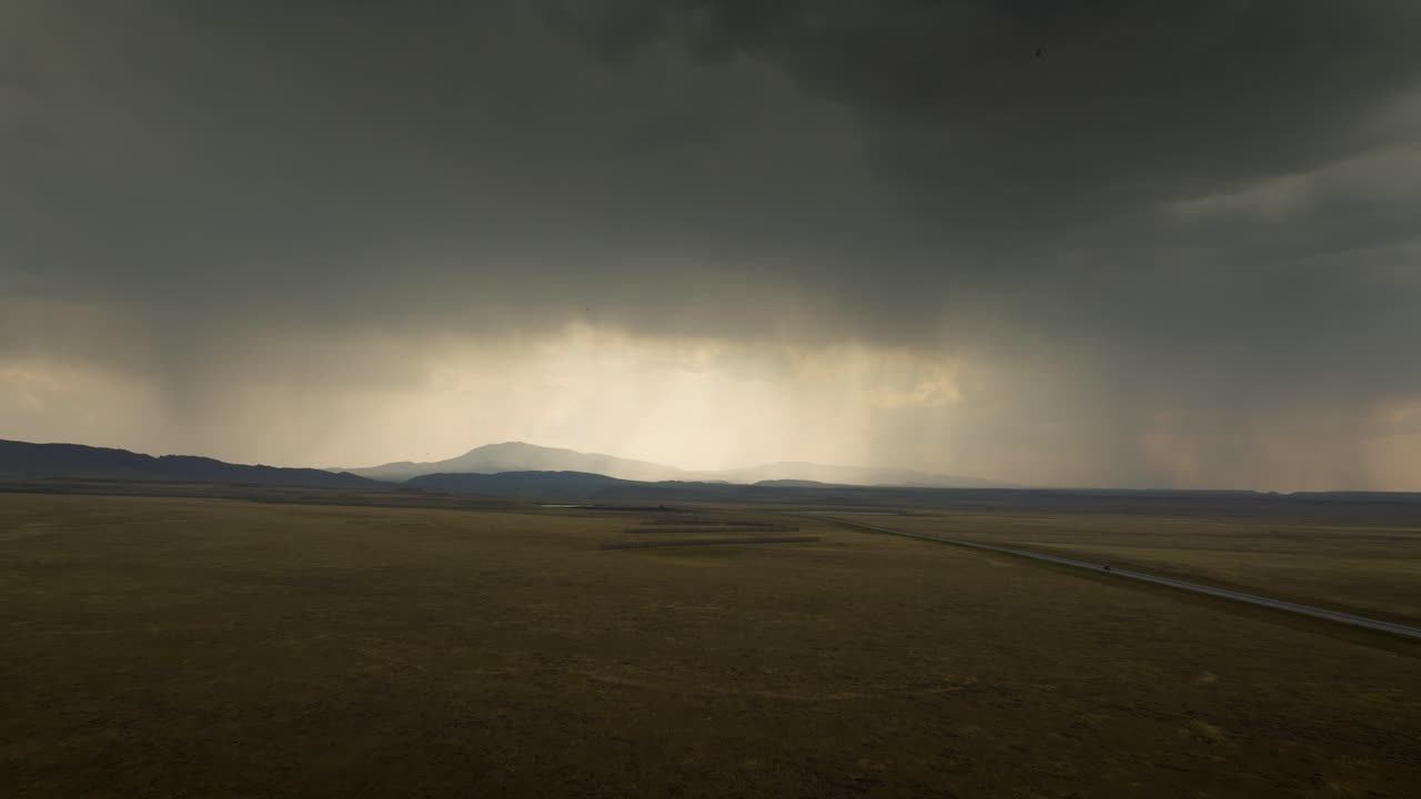 Dark clouds over WY-Road, USA create a moody, dramatic atmosphere