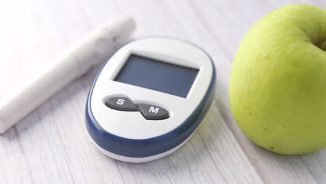 blood glucose meter and apple