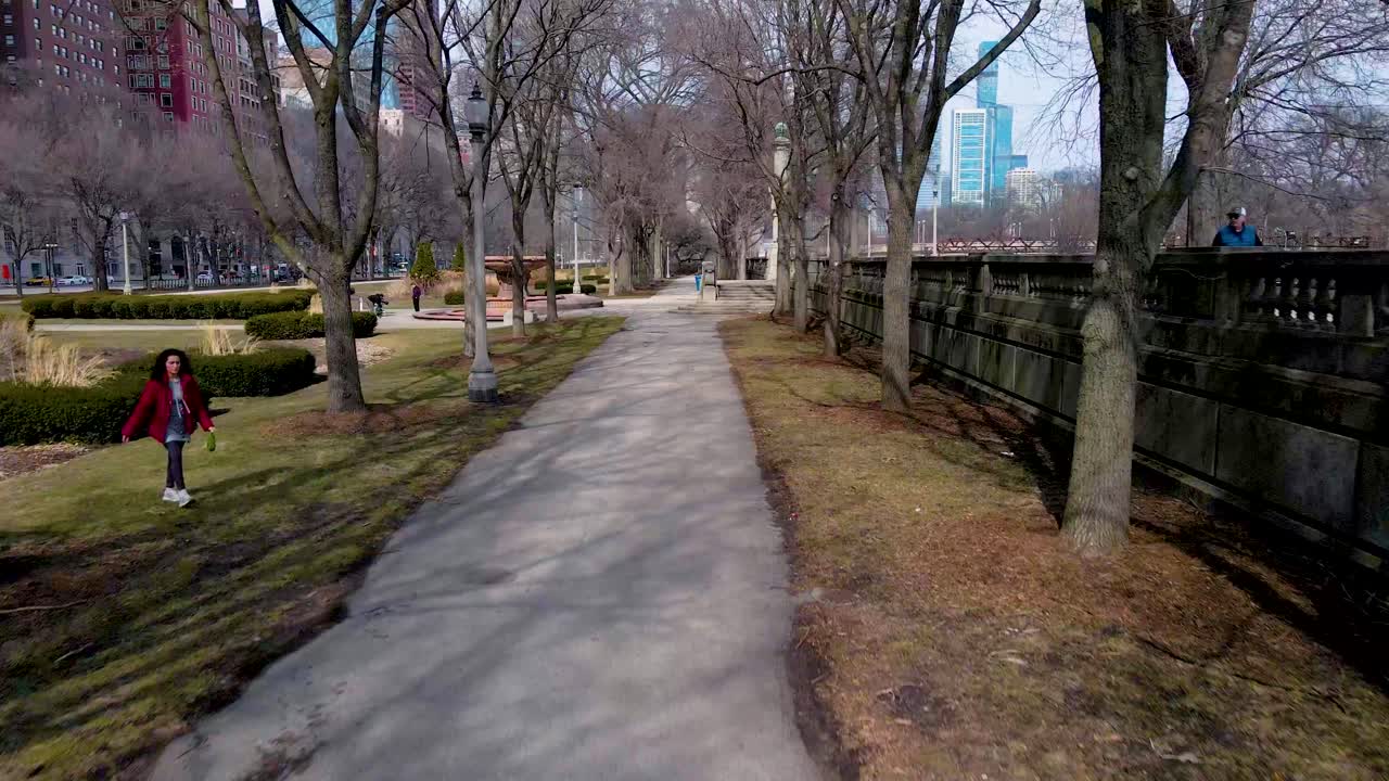 The Chicago park is a serene escape from the city's chaos. Amidst towering skyscrapers, people stroll the paths but fairly empty while birds chirp in the trees. related to park landscapes peacefulness