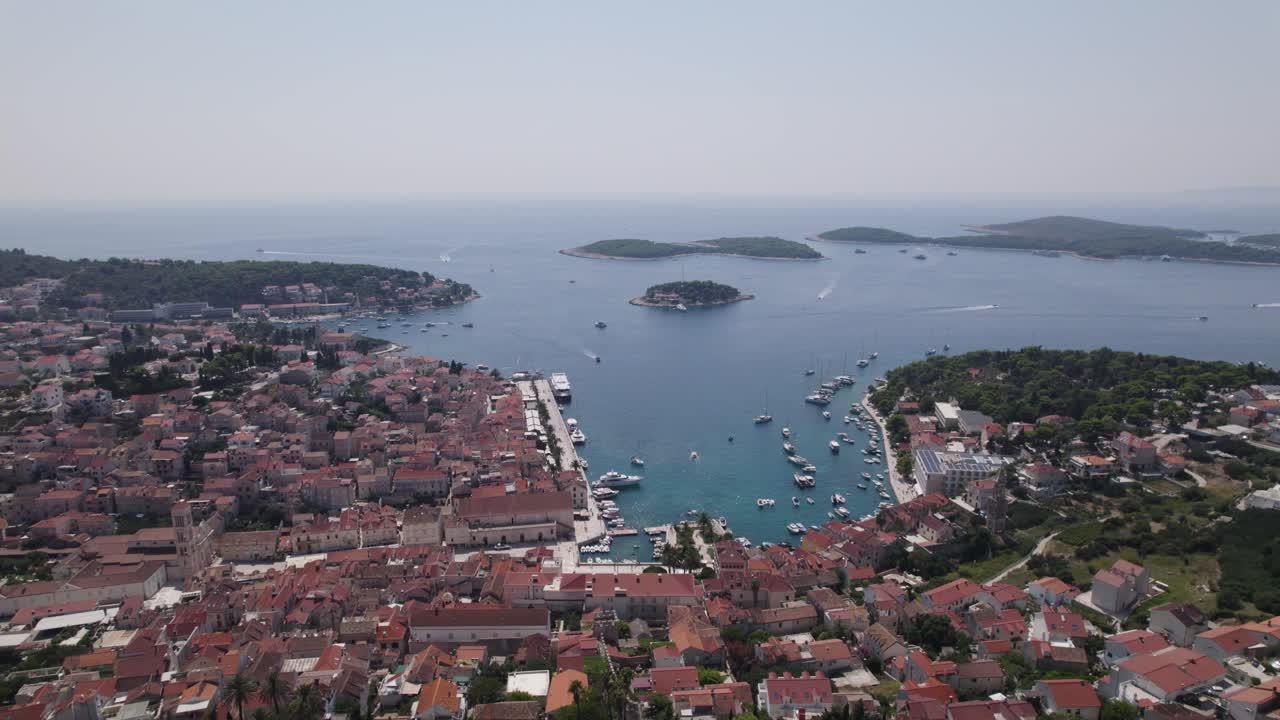 Croatia Aerial: Hvar's coast revealing Fortica Fortress overlooking serene harbor
