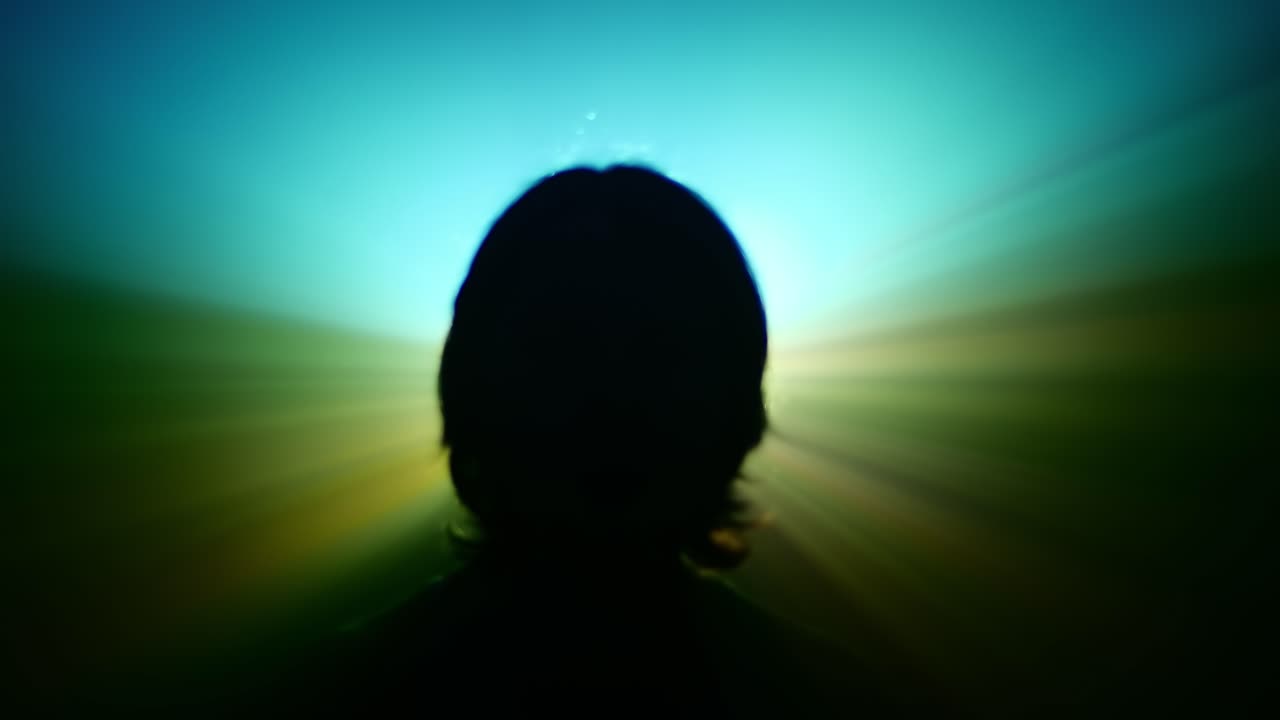 Silhouette of a Person Backlit by Bright Rays of Light