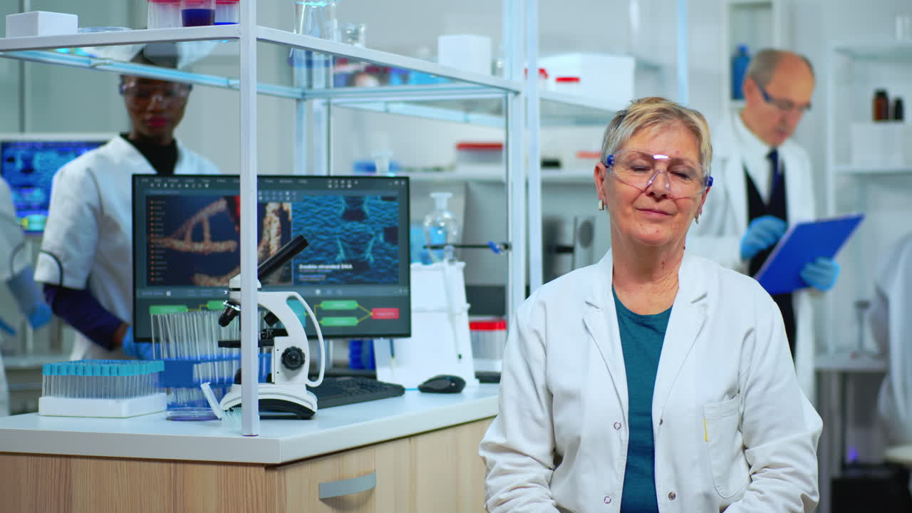Portrait of senior scientist woman looking at camera