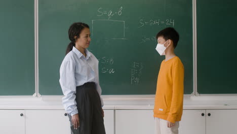 teacher and pupil at the blackboard.