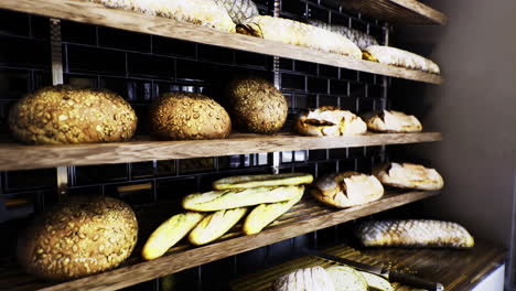 freshly baked bread displayed on wooden shelves in a bakery