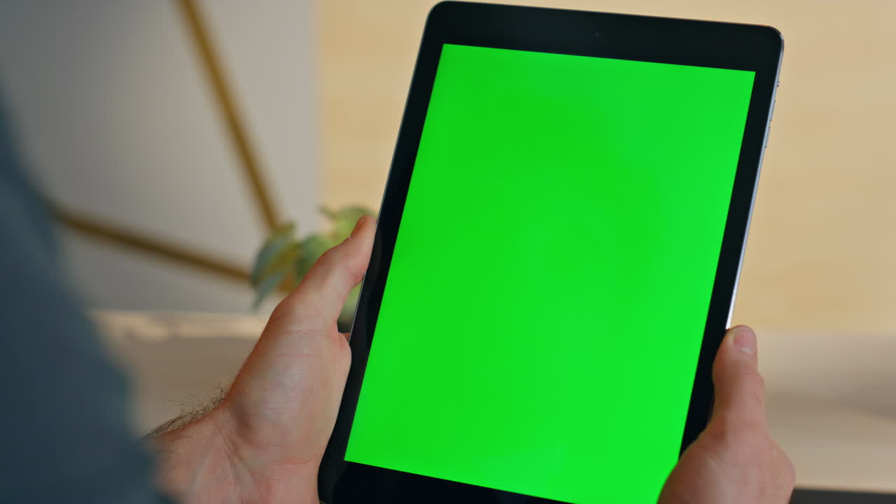 Unknown manager watching chromakey tablet desk closeup. Man hands holding device