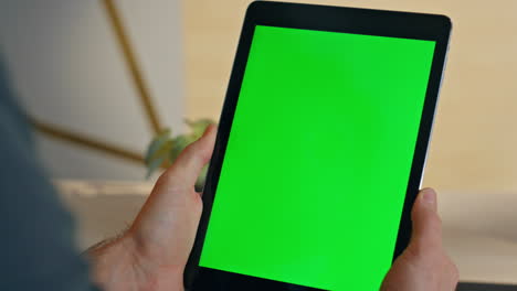 unknown manager watching chromakey tablet desk closeup. man hands holding device