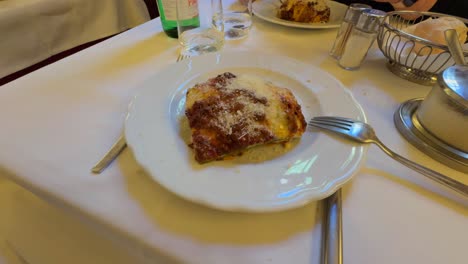 served lasagna with bolognese ragù dish on table - high angle, close up