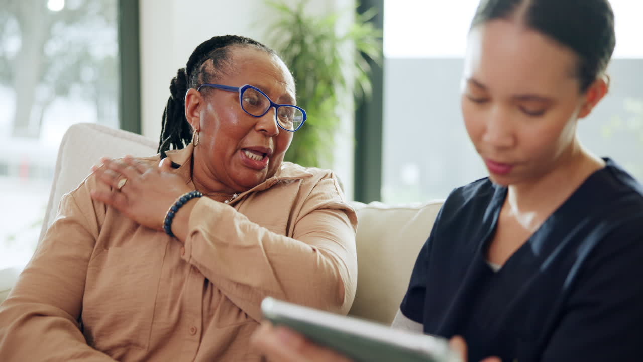 Healthcare Professional Consulting with Elderly Patient at Home