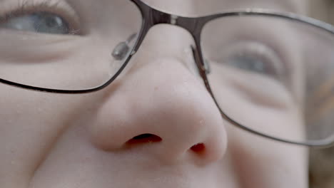 extreme closeup on a young boy's face as he is making an excited and happy reaction