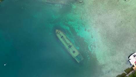 aerial view of a sunken ship in clear turquoise water