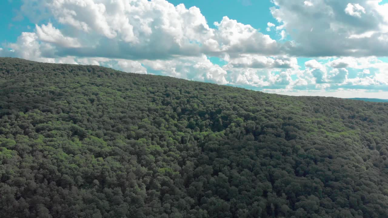Drone ascent over a mountain in the Catskill Mountains of New York State revealing a gorgeous hidden valley and sky
