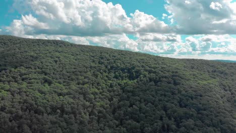 drone ascent over a mountain in the catskill mountains of new york state revealing a gorgeous hidden valley and sky