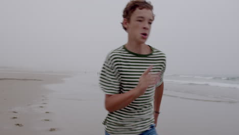 boy running on a foggy beach