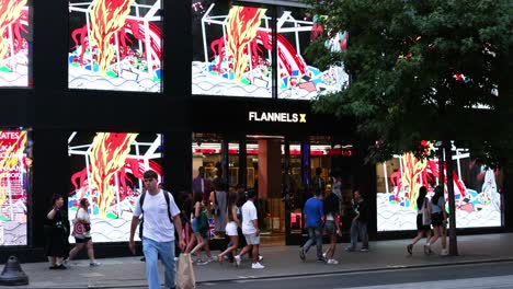 pedestrians walking past a vibrant storefront