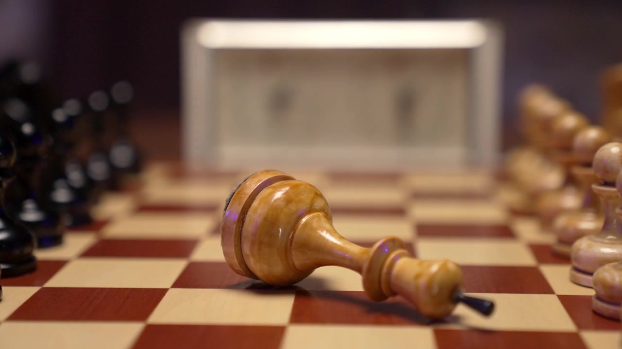 White Chess King Falling on Chessboard in Slow Motion