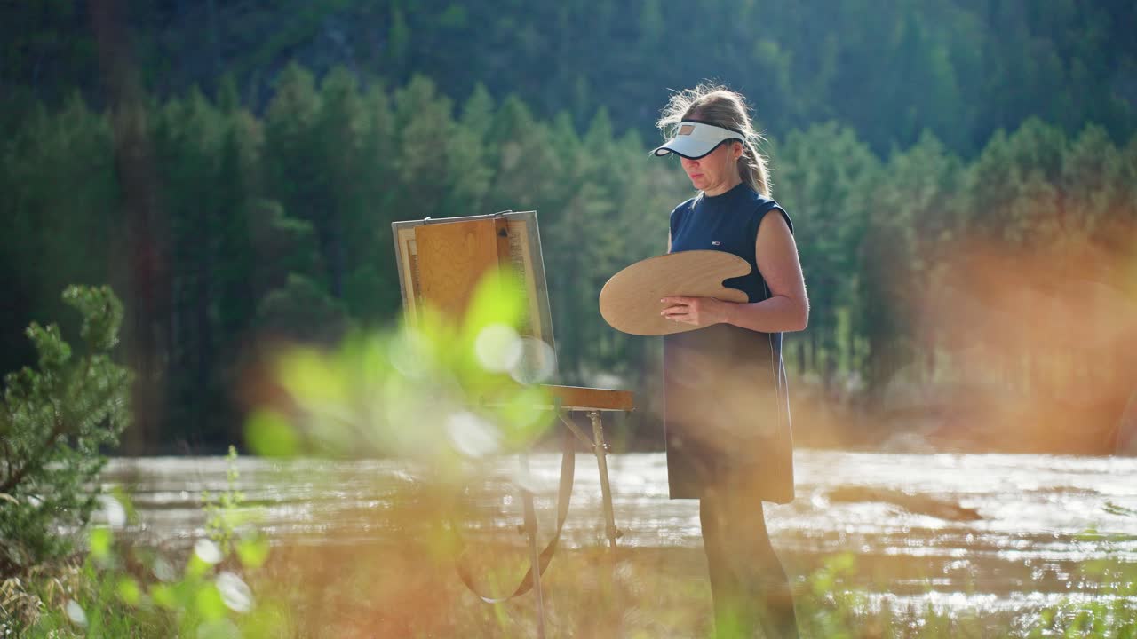 Artist Painting Outdoors by a River
