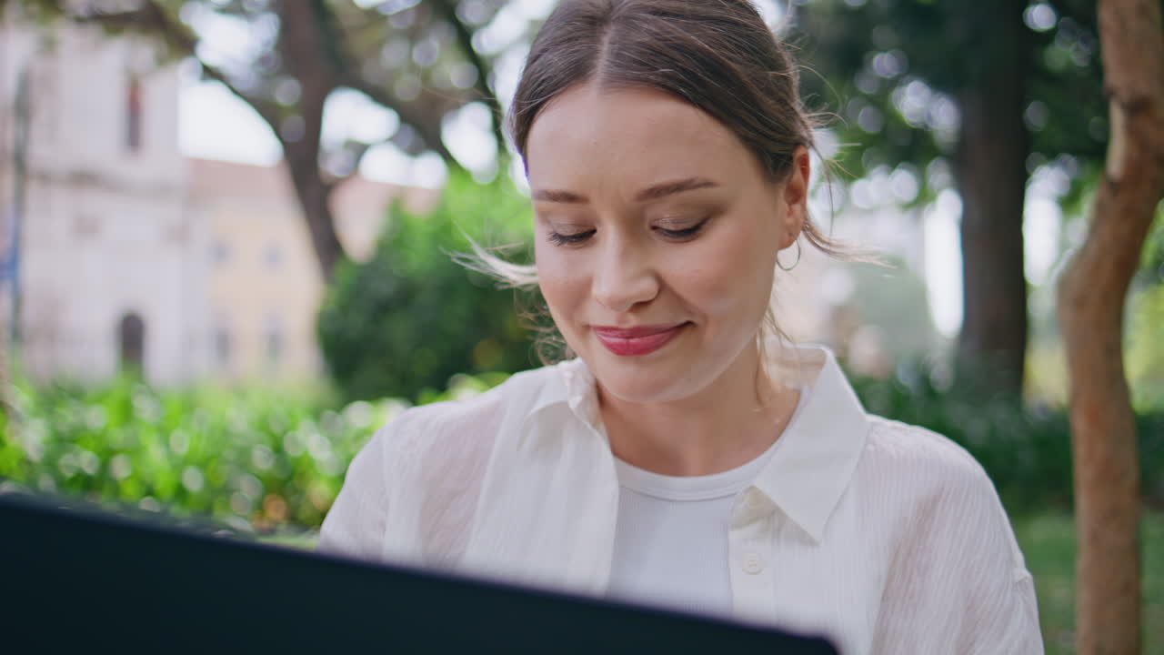 Businesswoman reading email park looking laptop screen closeup. Portrait woman