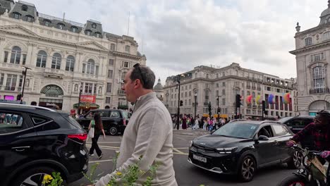 people and vehicles at bustling london intersection