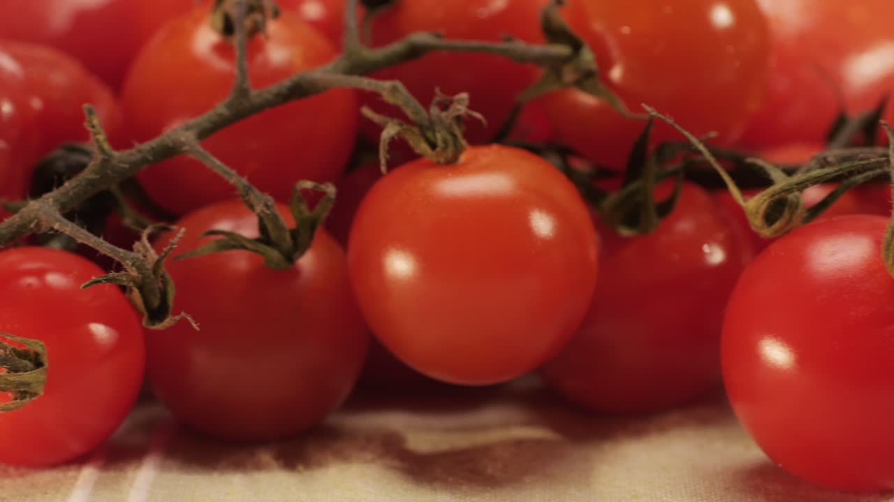 Colorful organic tomatoes. Mix tomatoes background, Several varieties of sliced tomatoes top view. Different assorted colorful tomatoes, heirloom, cherry, rose, beefsteak, cocktail, grape, purple.