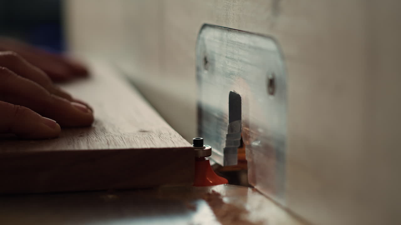Machinist at work performing tasks on wood shaper, close up