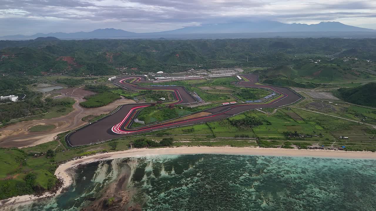Aerial pulls out: International moto race track on flat Lombok coast