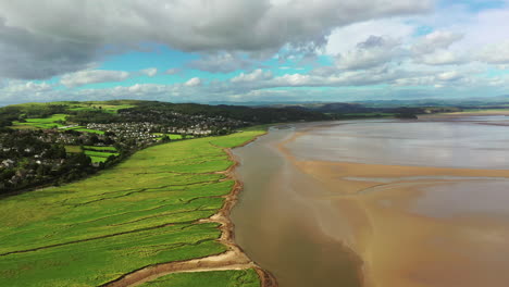 High-aerial-landscape-over-the-coast-line-in-the-north-of-England,-bright-blue-sky-day