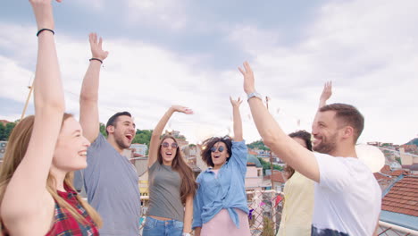 friends celebrating on a rooftop having