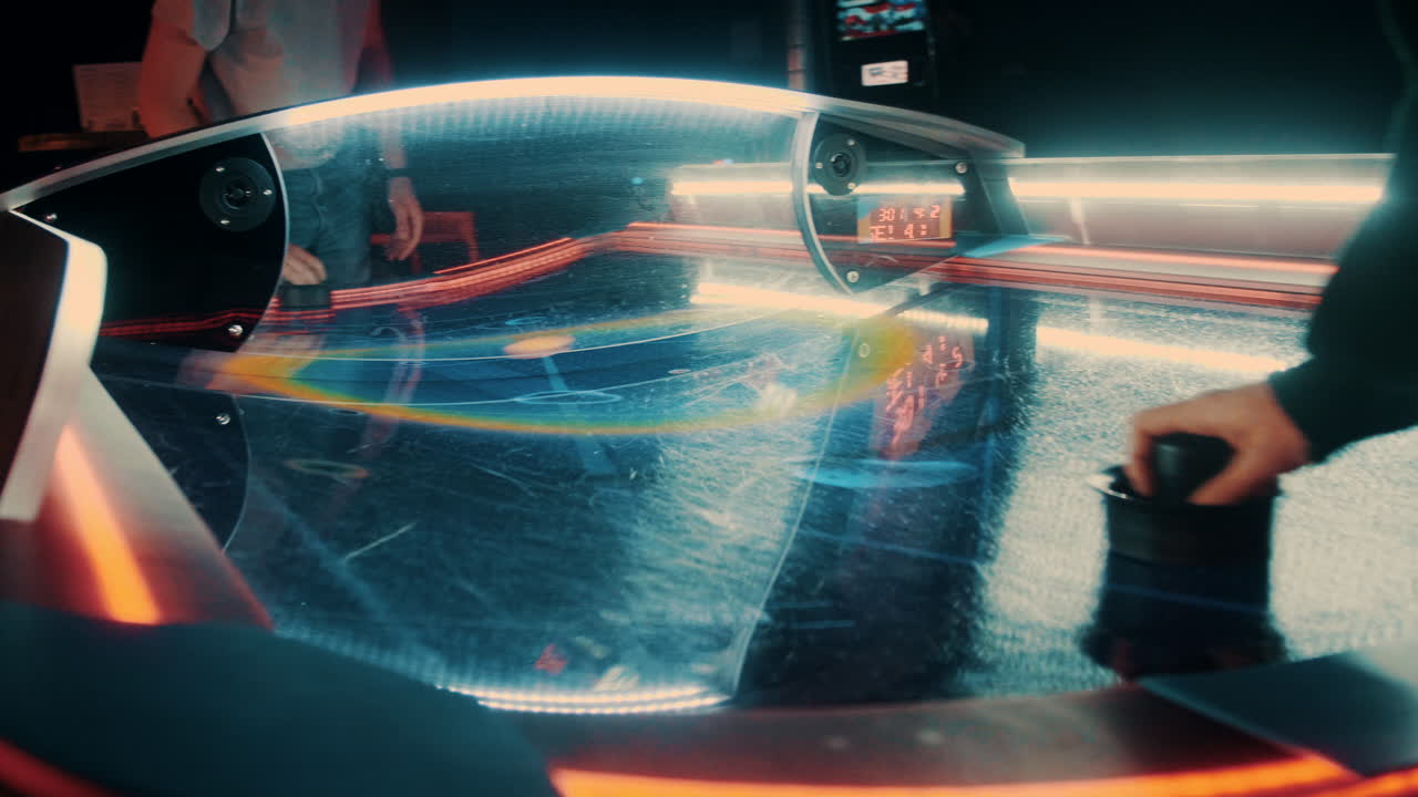 Scoring in a game of air hockey while the camera moves around the table