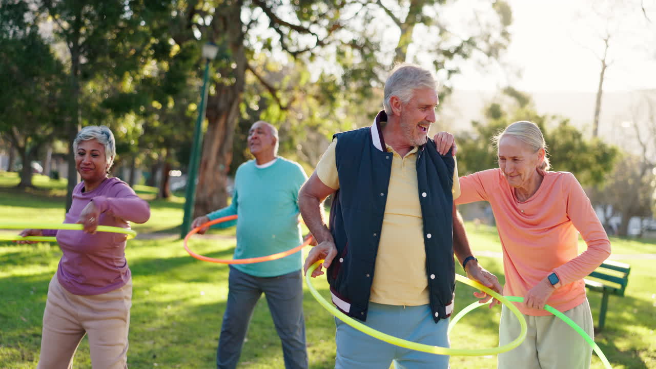 Group of Seniors Exercising with Hula Hoops in the Park