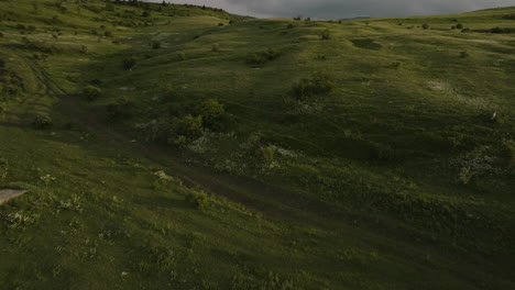 Flying-Over-Green-Fields-On-A-Cloudy-Day-In-Samtskhe-Javakheti,-Near-Akhaltsikhe-In-Georgia---drone-shot