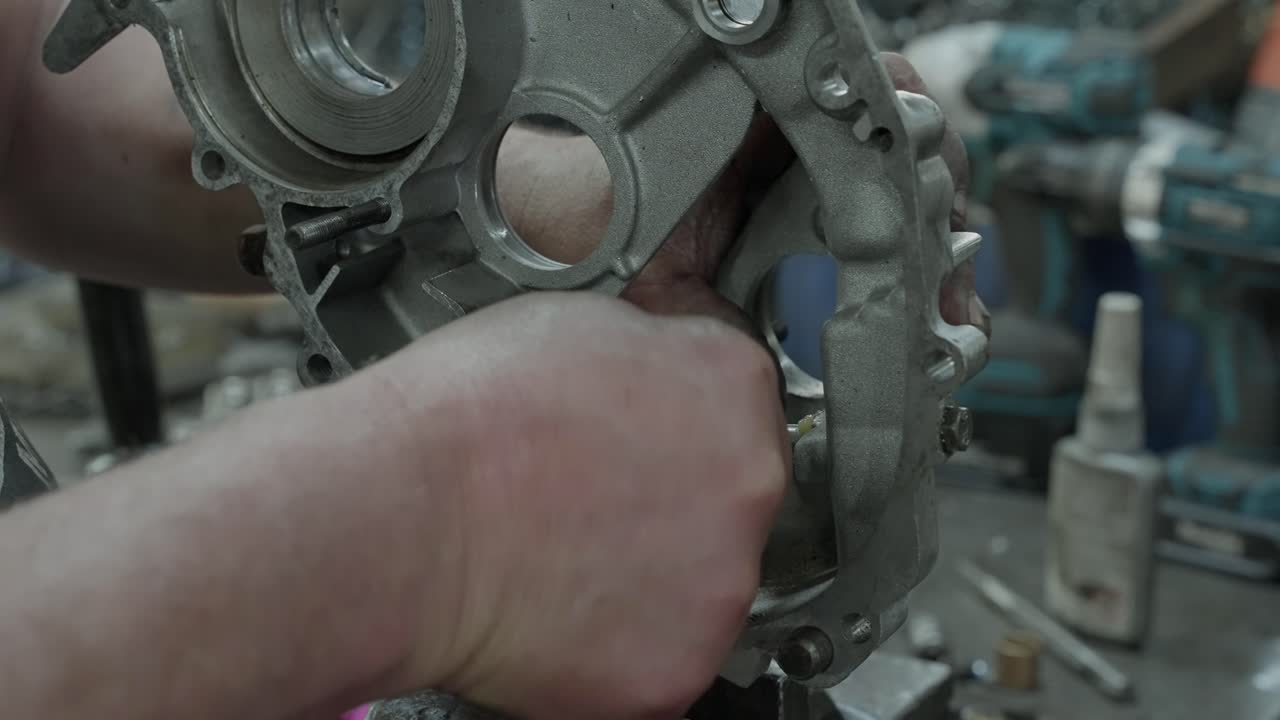 close up shot of internal metal component being aligned manually