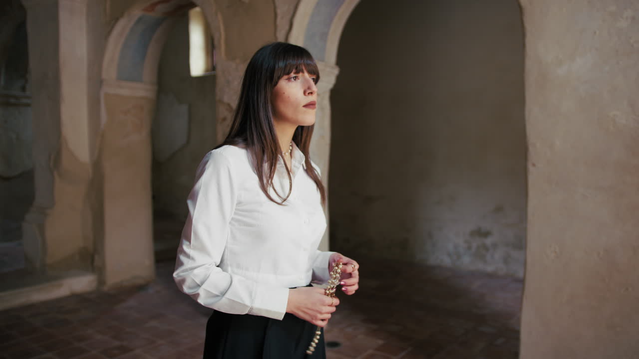 Woman Holding A Rosary In The Church Standing Still And Watching Up