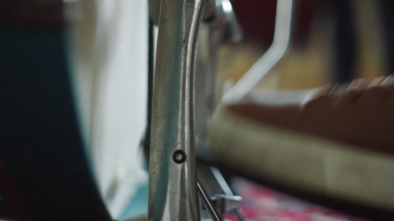 Foot in a brown sneaker on a drum pedal