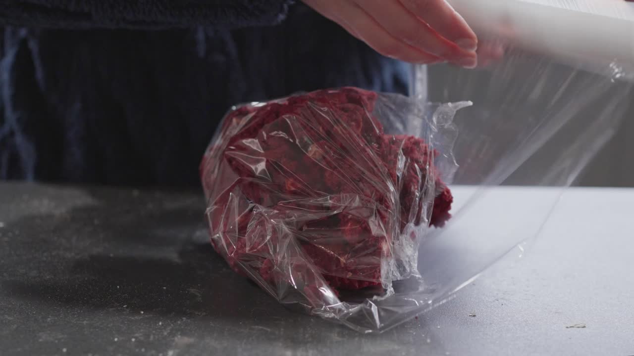Wrapping Red Velvet Cookie Dough in Plastic Wrap Close Up