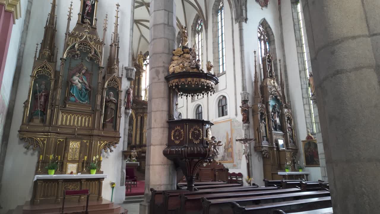 Establishing shot of Church of St. Vitus in Český Krumlov, Czechia, highlighting its Gothic architecture and cultural significance