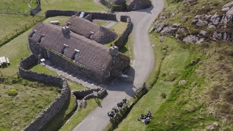 static drone shot of the gearrannan blackhouse village on the isle of lewis, part of the outer hebrides of scotland