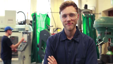 young mechanic smiling at camera