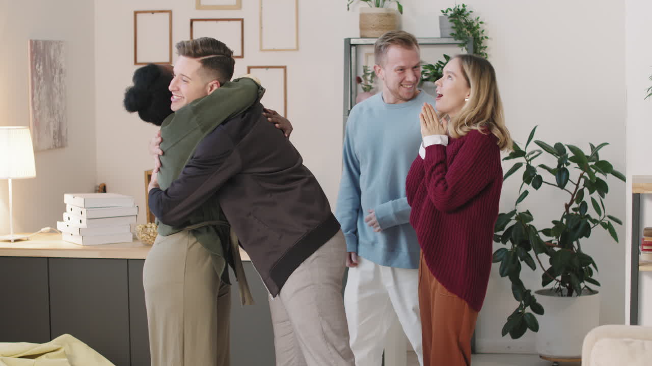 Young Woman Greeting Friends at Home