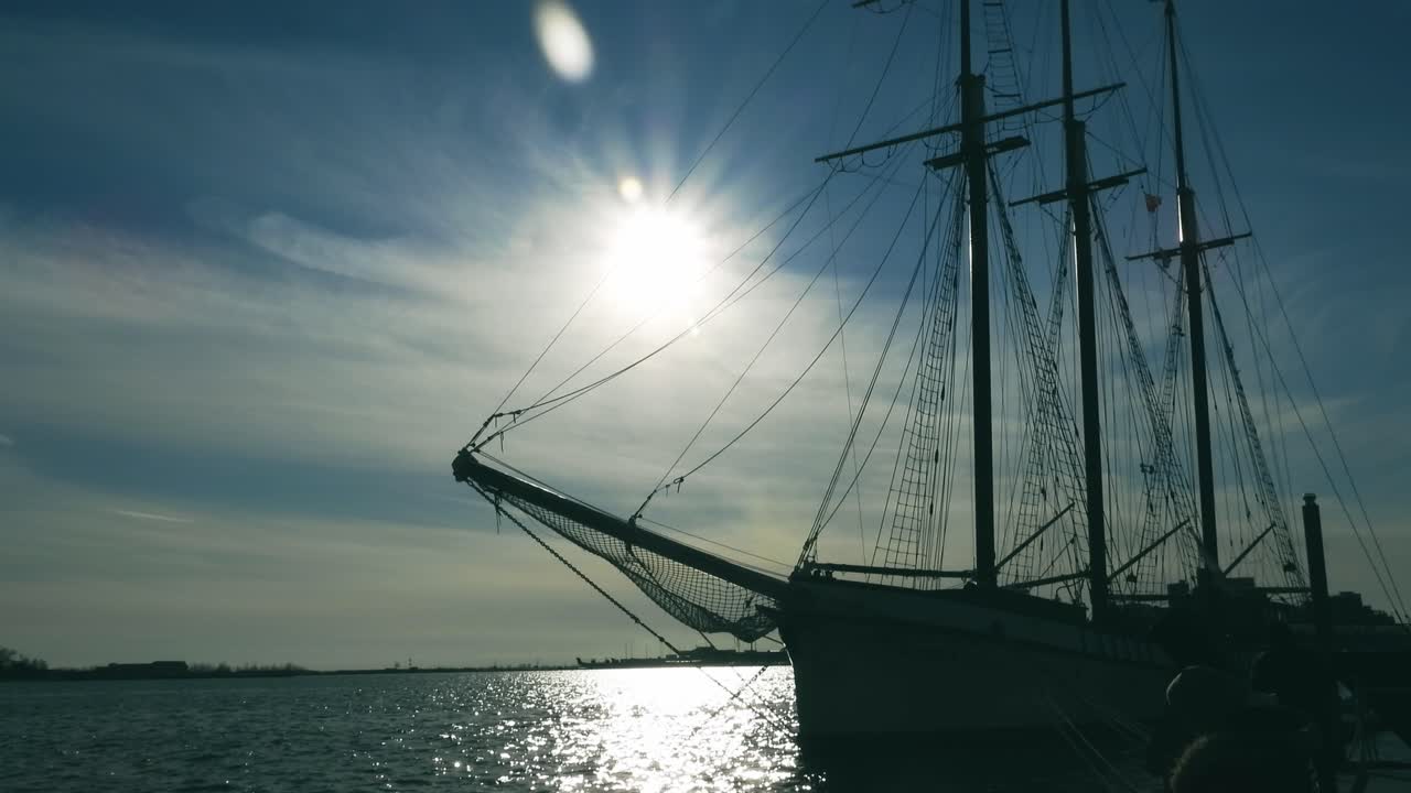 Anchored sailing vessel silhouette. Handheld