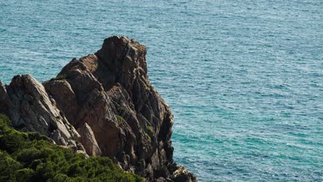 steep rocky cliff formations rise above the turquoise sea along tangier’s coastline