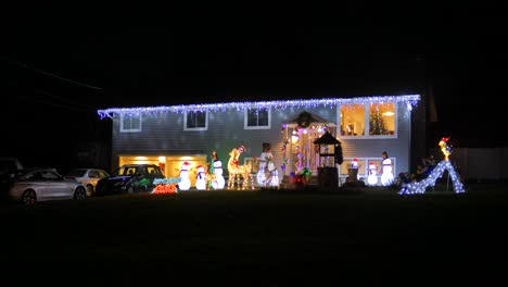 view of decorated illuminated for christmas and new year residential house and roof at night