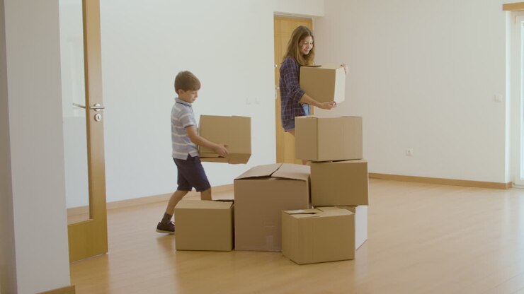 Excited family entering new house with cardboard boxes
