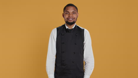 Portrait-of-restaurant-waiter-wearing-professional-uniform-and-apron