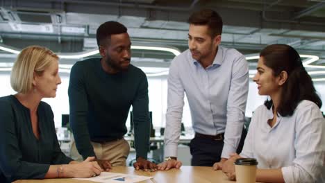 engaging collaboration among diverse professionals in a modern office setting: problem-solving and communication in action