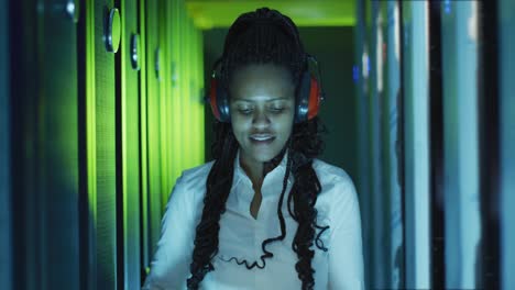 African-american-female-computer-technician-using-tablet-working-in-business-server-room