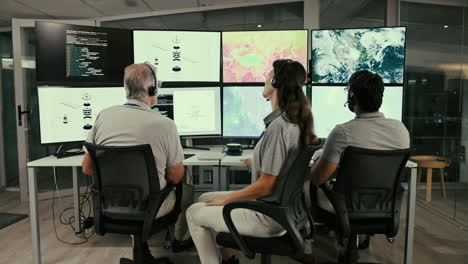 a team of professionals working in a control room