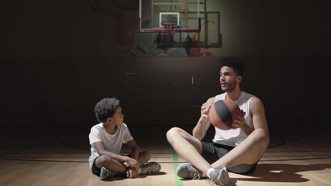 Basketball Player Teaching Boy