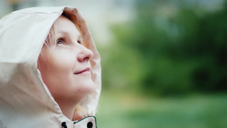 Portrait-Of-A-Young-Woman-Enjoying-The-Spring-Rain-Looking-Up-Hiking-And-Adventure-Freshness-Concept