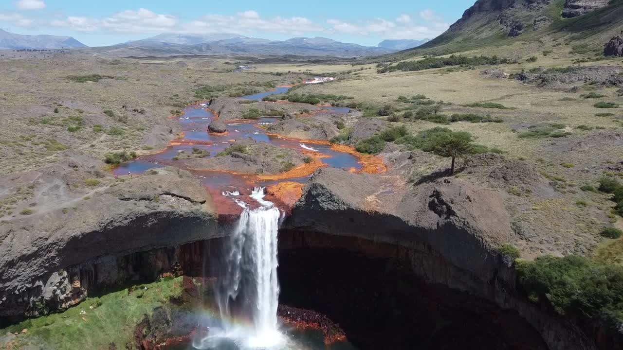 Unique waterfall with orange and blue colors as the acid water flows in Salto del Agrio in Argentina