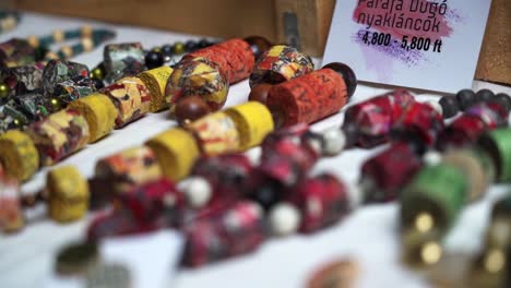 handmade colorful beads and jewelry for sale at a market